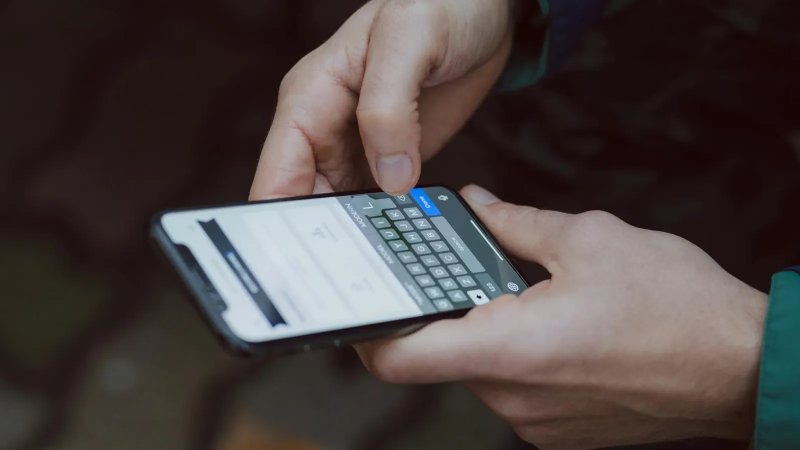Close-up of person texting on a smartphone. Outdoor setting with wireless connectivity.